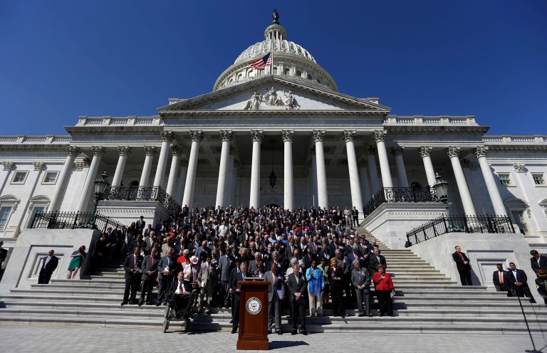 Members of Congress bow their heads in a moment of silence on Capitol Hill on Sept. 11, 2012. Lawmakers began the tradition on Sept. 11, 2001. (AP Photo/Alex Brandon)