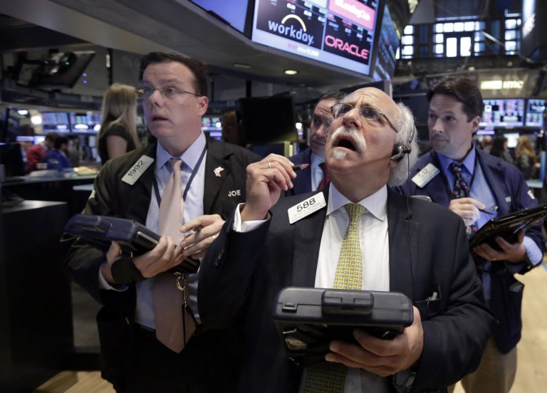 Peter Tuchman, foreground right, works with fellow traders on the floor of the New York Stock Exchange, Monday, Aug. 24, 2015. (AP Photo/Richard Drew)