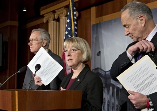 Sen. Patty Murray, D-Wash., center, chair of the Senate Budget Committee, holds up a copy of a 