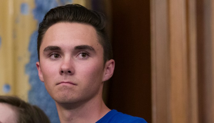 David Hogg, who survived the Stoneman Douglas High School shooting, stands during a news conference to announce the introduction of bipartisan legislation to expand background checks for sales and transfers of firearms, on Capitol Hill, Tuesday, Jan. 8, 2019 in Washington.