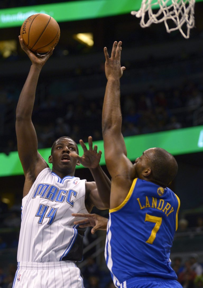   Orlando Magic forward Andrew Nicholson (44) puts up a shot in front of Golden State Warriors forward Carl Landry during the first half of an NBA basketball game in Orlando, Fla., Friday, Dec. 14, 2012. (AP Photo/Phelan M. Ebenhack)  