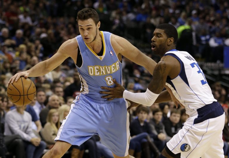   Denver Nuggets small forward Danilo Gallinari (8), of Italy, gets by Dallas Mavericks' O.J. Mayo (32) on a drive to the basket in the first half of an NBA basketball game on Friday, Dec. 28, 2012, in Dallas. (AP Photo/Tony Gutierrez)  