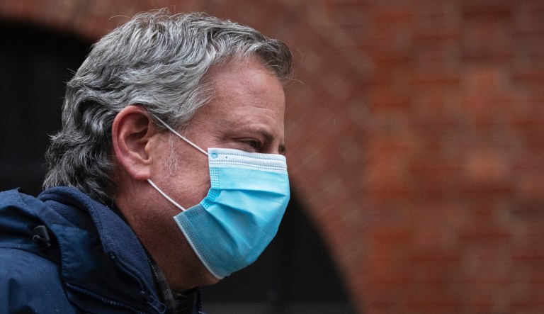 Mayor Bill de Blasio wears a mask during a 7 o'clock ceremony to honor healthcare workers at Brooklyn's Kings County Hospital Center during the new coronavirus pandemic, Friday, April 24, 2020, in New York.