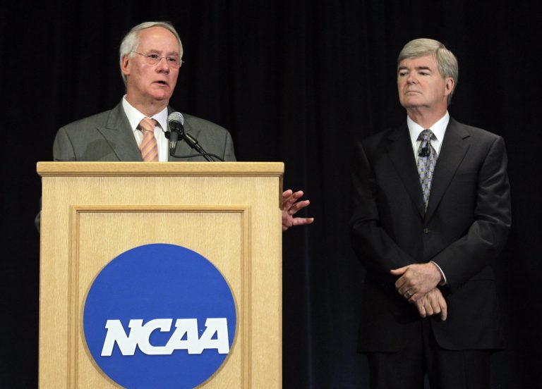 Ed Ray, left, NCAA Executive Committee chair and Oregon State University president, answers questions about the penalties against Penn State as NCAA President Mark Emmert, looks on during a news conference in Indianapolis, Monday, July 23, 2012. (AP Photo/Michael Conroy)