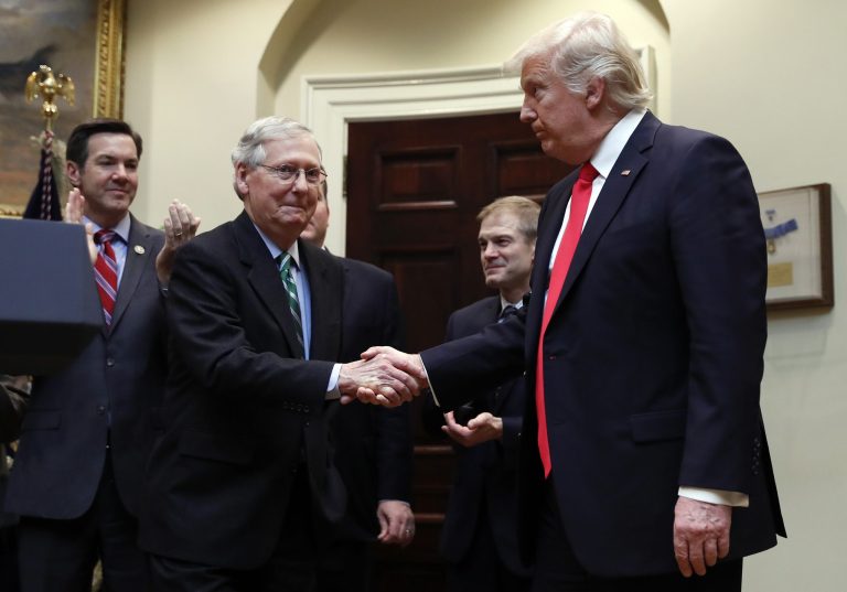  In this Feb. 16, 2017, file photo, President Trump shakes hands with Senate Majority Leader Mitch McConnell of Ky., during a ceremony in the Roosevelt Room of the White House in Washington. Behind from left are Rep. Evan Jenkins, R-W.Va., and Rep. Jim Jordan, R-Ohio.