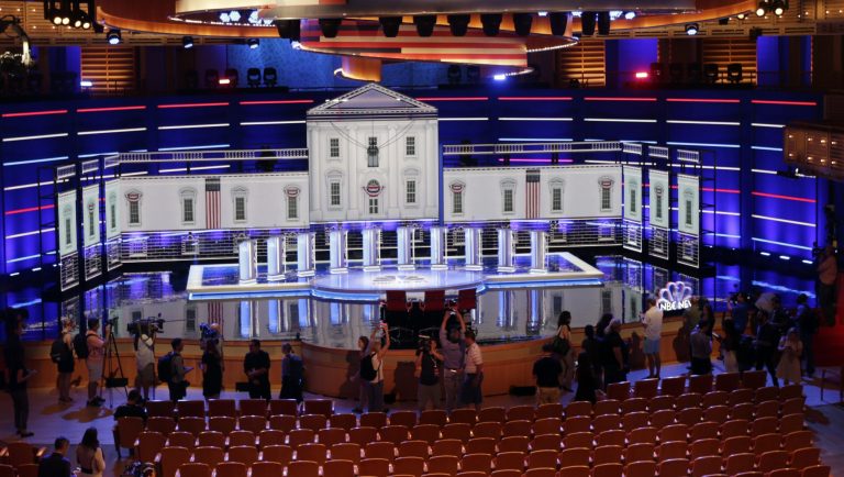 Members of the media gather for a walk-through of the stage set-up for the first democratic debate, Wednesday, June 26, 2019. Ten presidential candidates, led by Sen. Elizabeth Warren, are set to converge on the debate stage on the first night of Democratic debates to offer their pitches to the American people and attempt a breakout moment for their campaigns. 