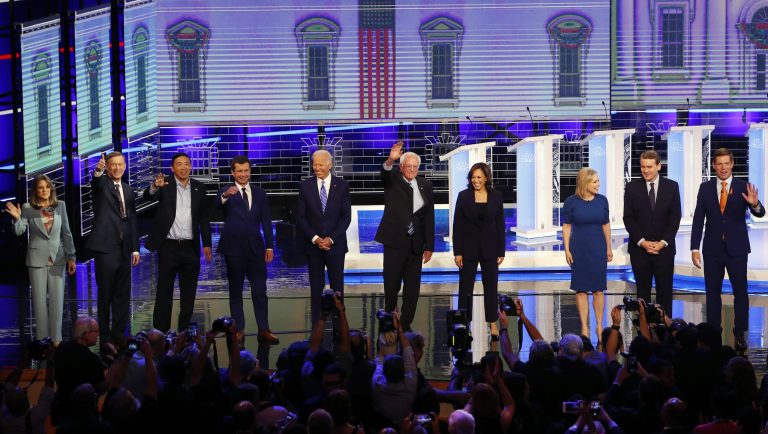 CORRECTS SPELLING OF GILLIBRAND'S FIRST NAME TO KIRSTEN, INSTEAD OF KRISTEN; CORRECTS BENNET'S TITLE TO SEN., INSTEAD OF FORMER SEN. - Democratic presidential candidates from left, author Marianne Williamson, former Colorado Gov. John Hickenlooper, entrepreneur Andrew Yang, South Bend Mayor Pete Buttigieg, former Vice-President Joe Biden, Sen. Bernie Sanders, I-Vt., Sen. Kamala Harris, D-Calif., Sen. Kirsten Gillibrand, D-N.Y., Colorado Sen. Michael Bennet and Rep. Eric Swalwell, D-Calif., wave as they enter the stage for the second night of the Democratic primary debate hosted by NBC News at the Adrienne Arsht Center for the Performing Arts, Thursday, June 27, 2019, in Miami.