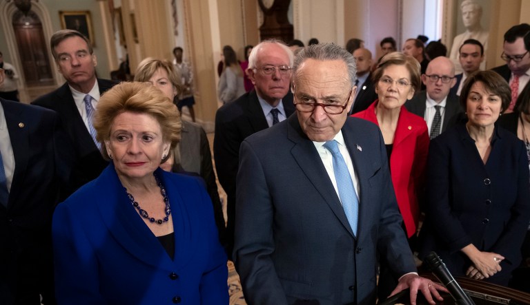 Senate Minority Leader Chuck Schumer, D-N.Y., is surrounded by the Senate Democratic Caucus as he talks to reporters at the Capitol in Washington, Wednesday, Nov. 14, 2018.