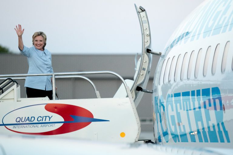Although Hillary Clinton took questions from journalists aboard the jet Monday, she cut the interaction short after suffering another coughing fit. (AP Photo)