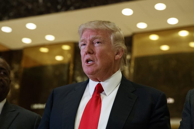President-elect Donald Trump speaks with reporters in the lobby of Trump Tower in New York, Friday, Jan. 13, 2017.