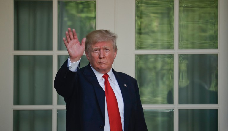 President Donald Trump waves as he returns to the Oval Office of the White House in Washington, Thursday, June 1, 2017, after speaking in the Rose Garden about the U.S. role in the Paris climate change accord.
