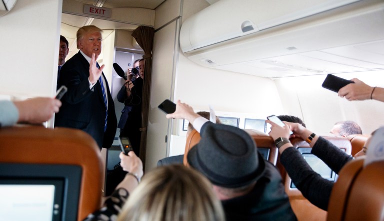 President Donald Trump talks with reporters aboard Air Force One on a flight to Andrews Air Force Base, Md., Thursday, April 5, 2018.