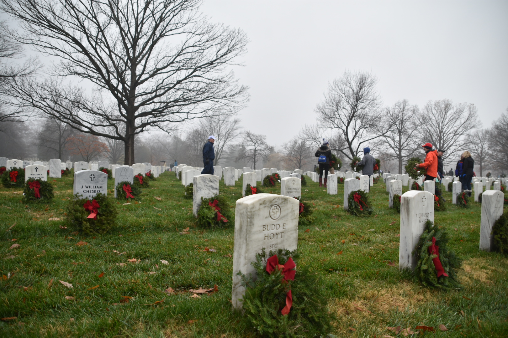 Volunteers lay wreaths at the grave sites of military service members in Arlington National Cemetery's Section 60. 