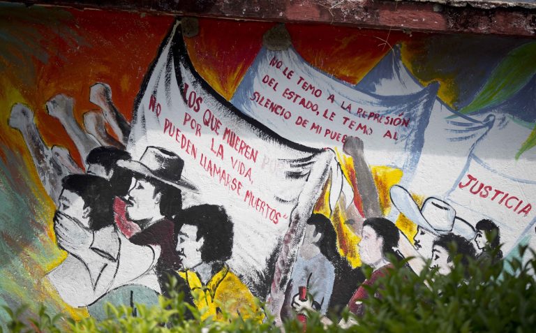 In this Oct. 6, 2014 photo, a mural with messages that read in Spanish; 