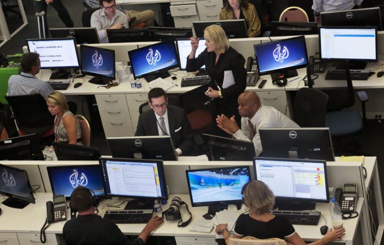 FILE - This Aug. 20, 2013 file photo shows Al-Jazeera America editorial newsroom staff preparing for their first broadcast in New York. Al-Jazeera America marks its first anniversary on the air next week. The news network has recorded some startlingly low ratings and recently shown signs of retrenchment with layoffs and by cutting some live newscasts. (AP Photo/Bebeto Matthews, File)
