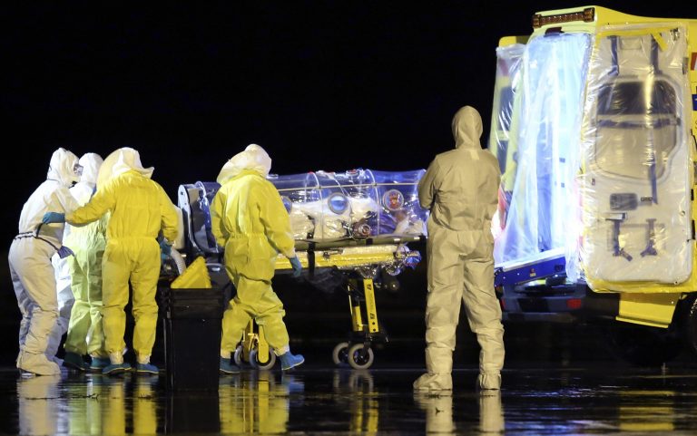 In this photo provided by the Spanish Defense Ministry, aid workers and doctors transfer Manuel Garcia Viejo, a Spanish priest who was diagnosed with the Ebola virus while working in Sierra Leone, from a military plane to an ambulance as he leaves the Torrejon de Ardoz military airbase, near Madrid, Spain, Monday, Sept. 22, 2014. The Spanish priest who was diagnosed with the Ebola virus while working in Sierra Leone has been flown back to Spain and taken to a Madrid hospital. Garcia Viejo, a medical director of the San Juan de Dios Hospital in the city of Lunsar in Sierra Leone, arrived on a medically equipped military plane shortly after 3 a.m. Monday. (AP Photo/Spanish Defense Ministry)