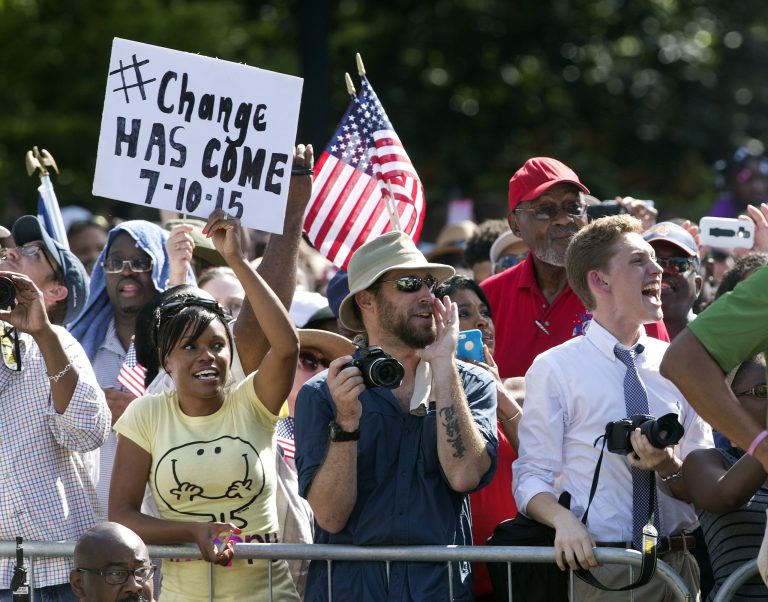 People cheer as an honor guard from the South Carolina Highway patrol removes the Confederate battle flag from the Capitol grounds Friday, July 10, 2015, in Columbia, S.C. (AP Photo/John Bazemore)