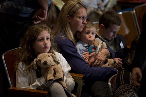 Residents wait for the start of an interfaith vigil for the victims of the Sandy Hook Elementary School shooting on Sunday, Dec. 16, 2012 at Newtown High School in Newtown, Conn. A gunman walked into Sandy Hook Elementary School Friday and opened fire, killing 26 people, including 20 children. (AP Photo/Evan Vucci)