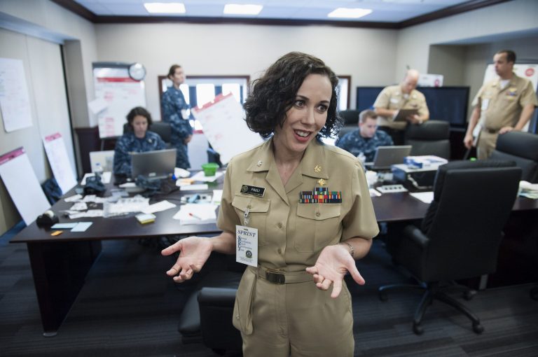   Navy Commander Ingrid Pauli directs the Special Psychiatric Intervention Team (SPRINT) command and control center at the Washington Navy Yard in Washington, Thursday, Sept. 26, 2013. More than 6,000 employees of the Washington Navy Yard have been offered counseling in the 10 days since a gunman killed 12 people. A specialized team of counselors has been at the site, working with people who say they've been anxious, sad and stressed since the Sept. 16 shooting. (AP Photo/Cliff Owen)  
