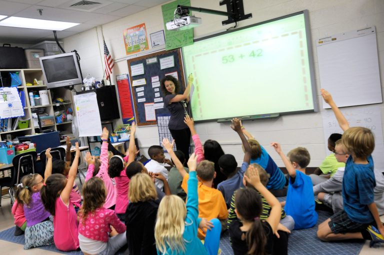 FILE - In this Oct. 1, 2013, file photo, third grade teacher Melissa Grieshober teaches a math lesson at Silver Lake Elementary School in Middletown, Del. Sometime in elementary school, you quit counting your fingers and just know the answer. Now scientists have put youngsters into brain scanners to find out why, and watched how the brain reorganizes itself as kids learn math. (AP Photo/Steve Ruark, File)