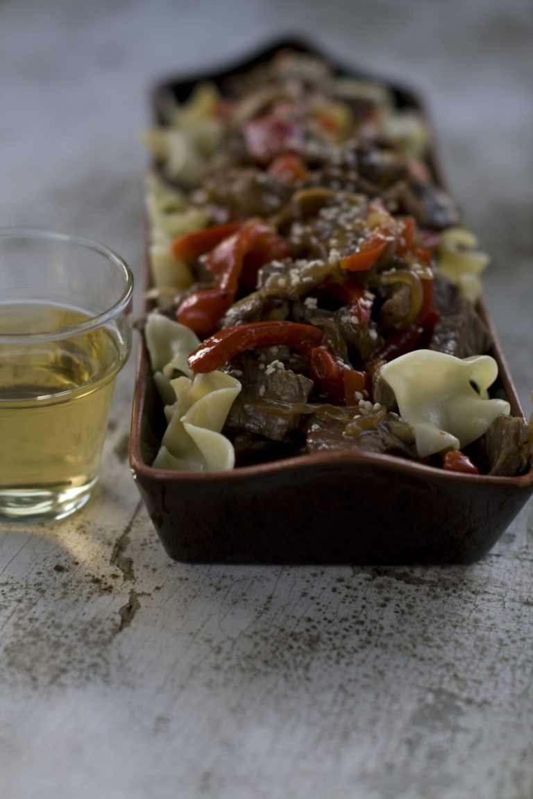   This undated image shows Mirin, a sweet Japanese cooking wine in a glass next to a sweet-and-savory recipe for short ribs tossed with egg noodles and shiitake mushrooms. The wine was used as a marinade for the dish. (AP Photo/Matthew Mead)  