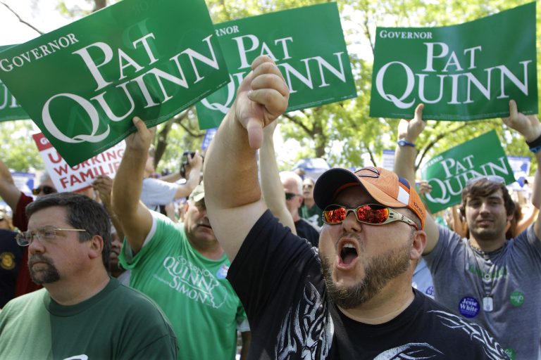 Mike Phillips, and other union protesters, supporters, and labor leaders boo Illinois Gov. Pat Quinn in protest saying he is betraying the Democratic party's tradition of supporting working men and women. (AP/Seth Perlman)