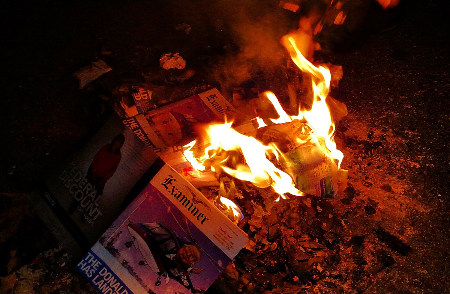 Watch: Protesters burn Washington Examiner magazines outside alt-right party