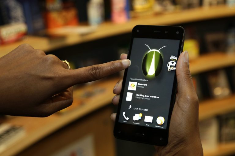 In this June 18, 2014 file photo, the new Amazon Fire Phone is demonstrated in Seattle. (AP Photo/Ted S. Warren, File)