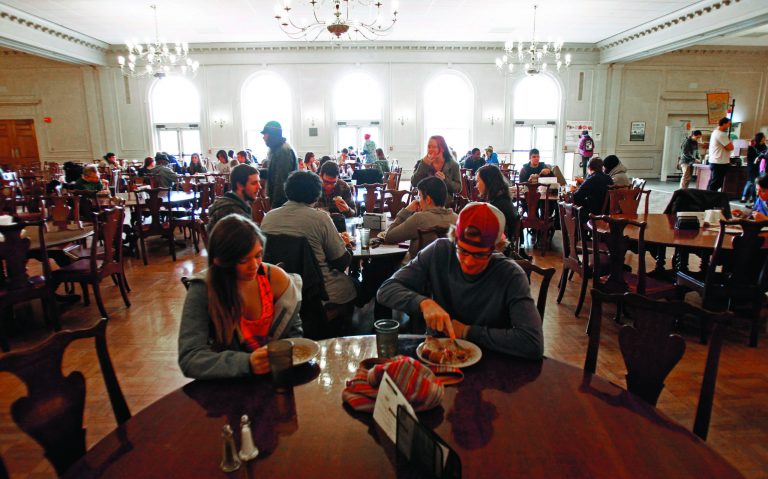 In this Thursday, Nov. 8, 2012 photo, students eat lunch in the dining hall at Green Mountain College, in Poultney, Vt. To officials at the small Vermont liberal arts college, a decision to slaughter two retired oxen and serve the meat in its dining halls is a matter of sustainable agriculture. But now, the school is under attack by those who want the oxen spared and have found a sanctuary for the animals. Opponents have signed online petitions and sent thousands of emails to staff members. The school received more than 3 million emails from Oct. 13 to Oct. 18 from one Internet domain, and got 200 emails from Spain, officials said. (AP Photo/Toby Talbot)