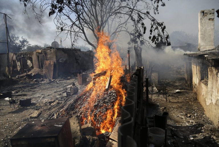 Homes burn after being hit by a shell in Donetsk, eastern Ukraine on Sept. 7. (AP Photo/Sergei Grits)