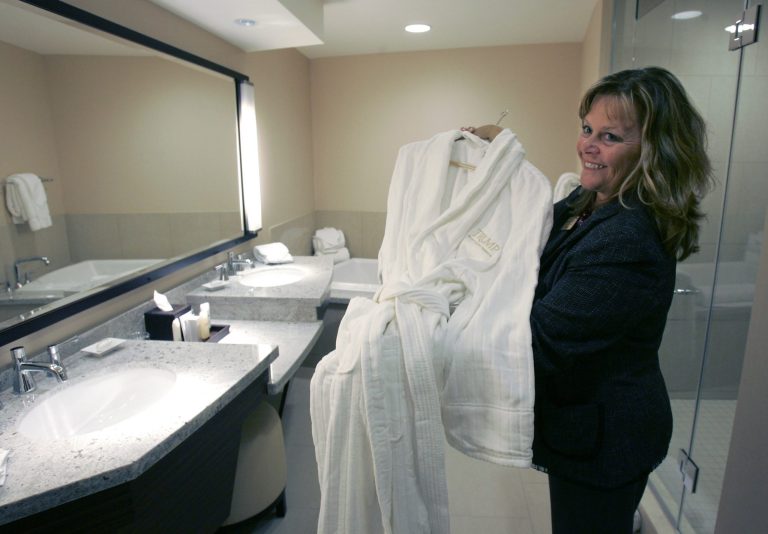 Mary Moyer, public relations manager for the Trump Taj Mahal Casino Resort, holds a Trump bathrobe in the Chairman Tower, a new $255 million hotel attached to the Taj Mahal Casino, in Atlantic City, N.J., Thursday, Sept. 2008. The new tower will have its grand opening ceremony this week, and investors will watch closely how it affects the company's bottom line. (AP Photo/Mike Derer)
