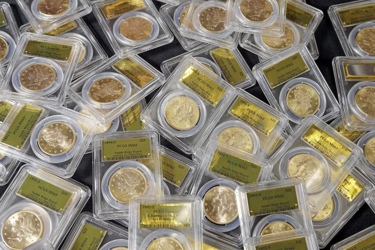 FILE - This Feb. 25, 2014 file photo shows some of the 1,427 Gold-Rush era U.S. gold coins displayed at Professional Coin Grading Service in Santa Ana, Calif. A treasure trove of rare gold coins discovered by a California couple out walking their dog is set to go on sale on Tuesday, May 27, 2014.  (AP Photo/Reed Saxon, File)