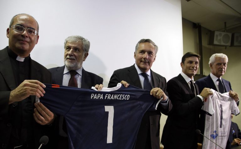 Form left, papal Master of Ceremonies Mosnignor Guillermo Karcher, Italian Entrepreneur Alfredo Altavilla, President of Charity Foundation PUPI Andres De La Fuente, Inter of Milan Vice-President Javier Zanetti and Italian Entrepreneur Marco Tronchetti Provera hold soccer jerseys bearing the name of Pope Francis as they pose for the photographers prior to the start of a press conference presenting a inter-religious football match for peace, in Rome, Monday, Aug. 25, 2014. The friendly soccer match, supported by Pope Francis to promote the dialogue and peace among different religions, is scheduled at Rome's Olympic stadium, Sept. 1. (AP Photo/Gregorio Borgia)