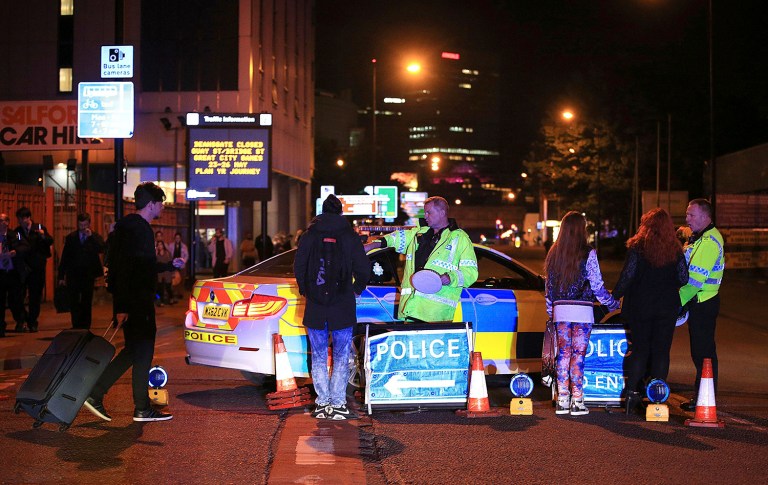 Emergency services work at Manchester Arena after reports of an explosion at the venue during an Ariana Grande gig in Manchester, England Monday, May 22, 2017. Several people have died following reports of an explosion Monday night at an Ariana Grande concert in northern England, police said. A representative said the singer was not injured. (Peter Byrne/PA via AP)