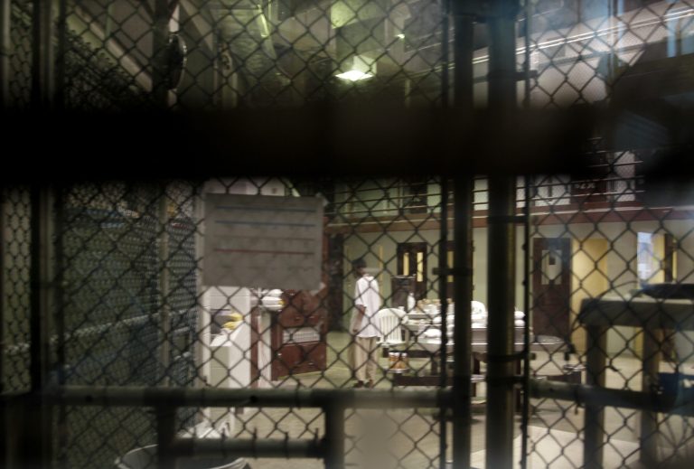 In this photo reviewed by a U.S. Department of Defense official, a prisoner walks through a communal pod inside an area of the Guantanamo Bay detention center known as Camp 6, an area for prisoners who are considered 