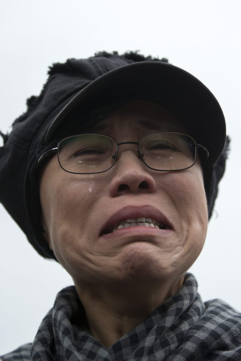 FILE - In this June 9, 2013 file photo, Liu Xia, the wife of imprisoned Nobel Peace Prize winner Liu Xiaobo, cries outside Huairou Detention Center where her brother Liu Hui has been jailed in Huairou district, on the outskirts of Beijing, China. The health of Liu has deteriorated under lengthy house arrest and she urgently requires medical treatment, close friends said Friday, Feb. 14, 2014. (AP Photo/Alexander F. Yuan, File)