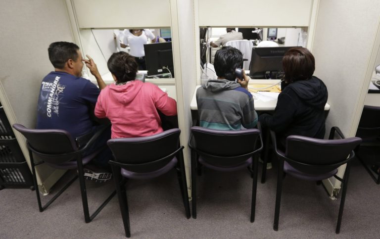 People use a a phone bank to sign up for health care insurance at the business office of Parkland Hospital in Dallas on March 31. Monday is the deadline to sign up for private heath insurance in the online markets created by President Obama's heath care law. (AP Photo/LM Otero)