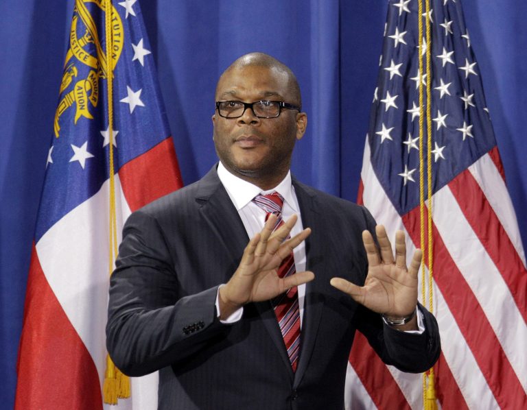 FILE - In this Friday, March 16, 2012 file photo, filmmaker and actor Tyler Perry takes the stage to introduce President Barack Obama during a fundraiser at Perry's film studio, in Atlanta. Perry has surprised middle school students in Ohio by showing up at a musical concert and donating $100,000 to help student athletes in the city's South-Western schools. (AP Photo/David Goldman, File)