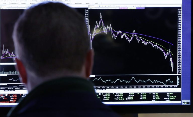 FILE - In this Jan. 29, 2014, file photo, a specialist works at his post on the floor of the New York Stock Exchange. Companies in the U.S. are reporting strong earnings for the fourth quarter of last year, but investors are not satisfied. (AP Photo/Richard Drew, File)