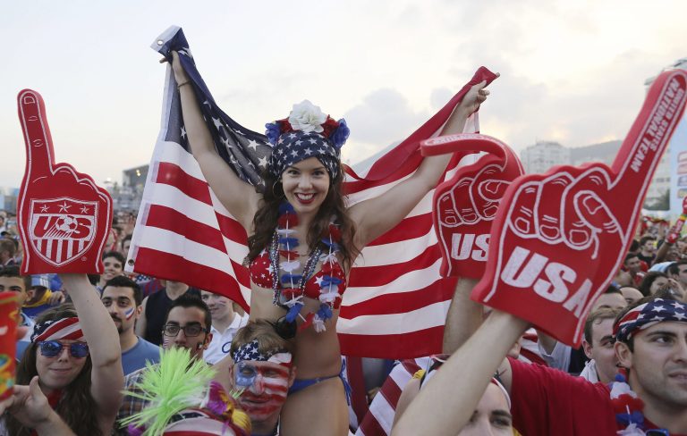 A U.S. soccer fan holds a representation of her country's flag as fans wait for the start of the World Cup round of 16 match against Belgium on a live telecast inside the FIFA Fan Fest area on Copacabana beach in Rio de Janeiro, Brazil, Tuesday. (AP/Leo Correa)