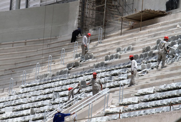 In this photo released by Portal da Copa, workers install seats at the Arena da Baixada stadium in Curitiba, Brazil, Tuesday, Jan. 21, 2014. FIFA Secretary General Jerome Valcke is giving Brazilian organizers only a few more weeks to show that the stadium in Curitiba will be ready in time for the World Cup. Most of the delay at the venue, which was about 90 percent completed, was blamed on difficulties getting the needed funding for the construction. The stadium is being built mainly by local club Atletico Paranaense. (AP Photo/Portal da Copa, Paulino Menezes)