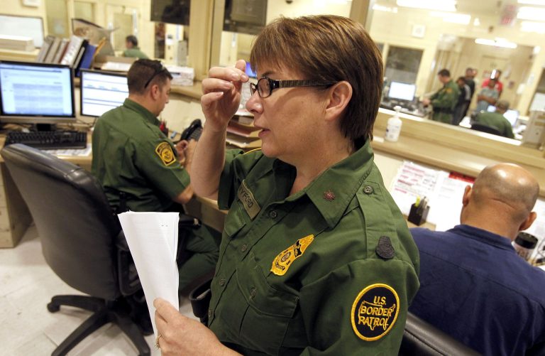 U.S. Border Patrol Tucson Sector Branch Chief Donna Twyford examines an illegal immigrant's file as they are processed at Tucson Sector U.S. Border Patrol Headquarters Thursday, Aug. 9, 2012, in Tucson, Ariz. (AP Photo/Ross D. Franklin)