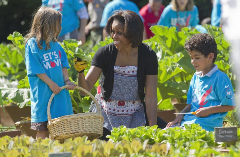FILE - In this June 3, 2011, file photo, first lady Michelle Obama tends the White House garden in Washington, with a group of children as part of the 