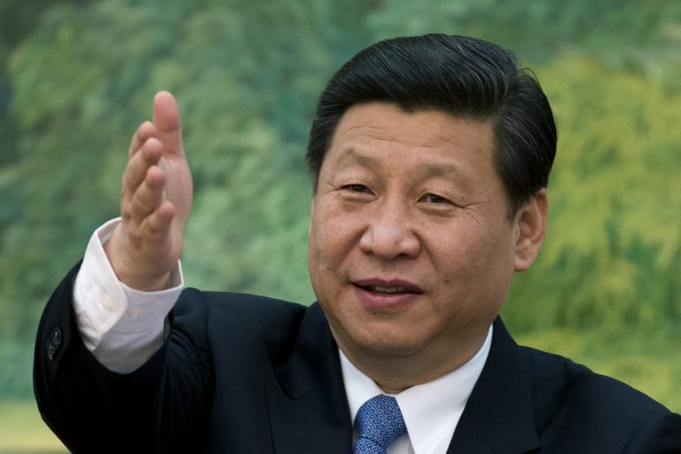   FILE - In this Wednesday, Dec. 5, 2012 file photo, China's newly appointed leader Xi Jinping gestures as he attends a meeting with foreign experts at the Great Hall of the People in Beijing. New communist leader Xi is on a mission to soften the image of Chinese officialdom, winning kudos for his breezy personal style and ordering leaders to take a knife to the pomp, formality and waste that have alienated many among the public. (AP Photo/Ed Jones, Pool)  