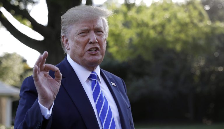 President Donald Trump talks with reporters on the South Lawn of the White House.