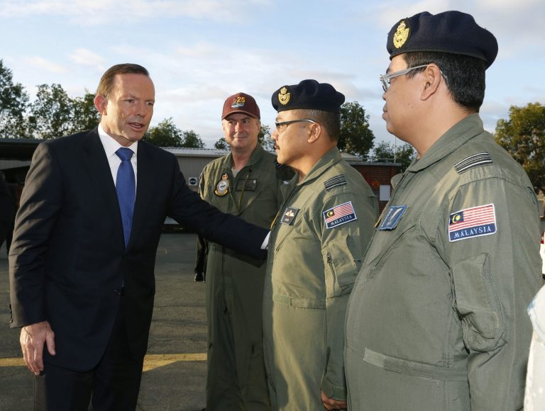 Australian Prime Minister Tony Abbott meets members of Malaysia's Air Force currently based at RAAF Base Pearce in Bullsbrook, near Perth, Australia, Monday, March 31, 2014. Abbott said the search for Malaysia Airlines Flight 370 is 