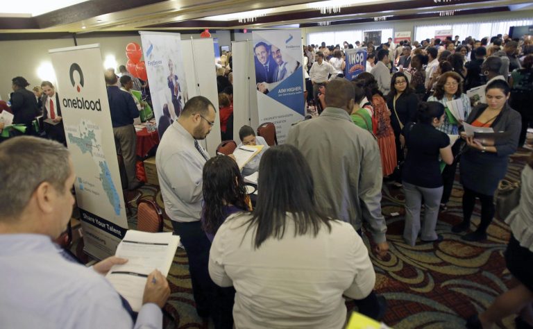   FILE - In this Wednesday, Aug. 14, 2013 file photo, job seekers check out companies at a job fair in Miami Lakes, Fla. The Labor Department reports on the number of Americans who applied for unemployment benefits on Thursday, Oct. 3, 2013. (AP Photo/Alan Diaz, File)  