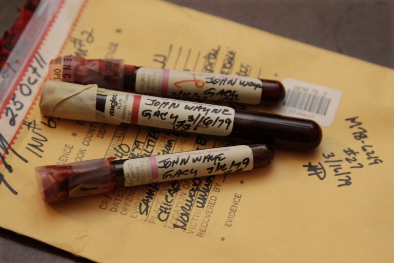   This photo taken Friday, Nov. 30, 2012, in Chicago shows three vials of mass murderer John Wayne Gacy's blood recently discovered by Cook County Sheriff's detective Jason Moran. The sheriffâs office is creating DNA profiles from the blood of Gacy and other executed killers and putting them in a national DNA database of profiles created from blood, semen, or strands of hair found at crime scenes and on the bodies of victims. What they hope to find is evidence that links the long-dead killers to the coldest of cold cases and prompt authorities in other states to submit the DNA of their own executed inmates and maybe evidence from decades-old crime scenes to help them solve their own cases. (AP Photo/M. Spencer Green)  