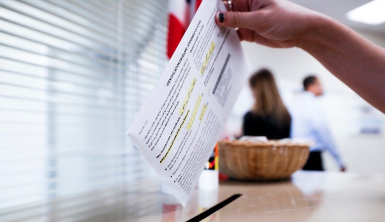 A voter casts their ballot on the first day of early voting at the Hamilton County Board of Elections, Wednesday, Oct. 10, 2018, in Cincinnati.