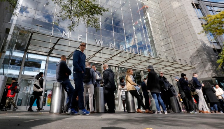 People gather outside the Time Warner Center in New York, Wednesday, Oct. 24, 2018.